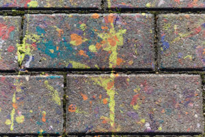 multicolored spots of paint on a concrete slab