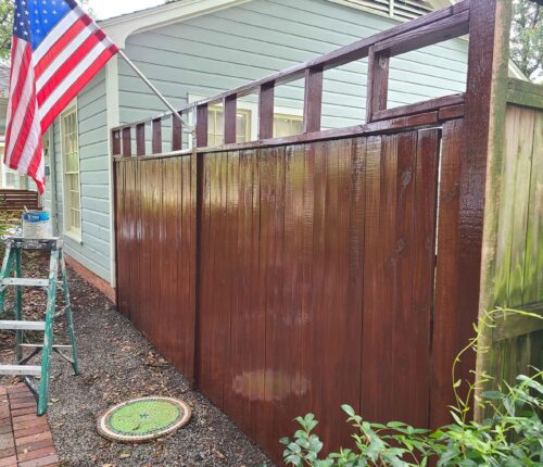 wooden fence with brown paint- JMA Painters