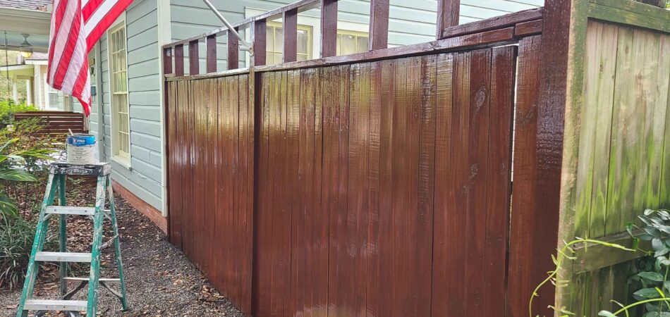 wooden fence with brown paint- JMA Painters