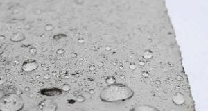 Water droplets on concrete up close